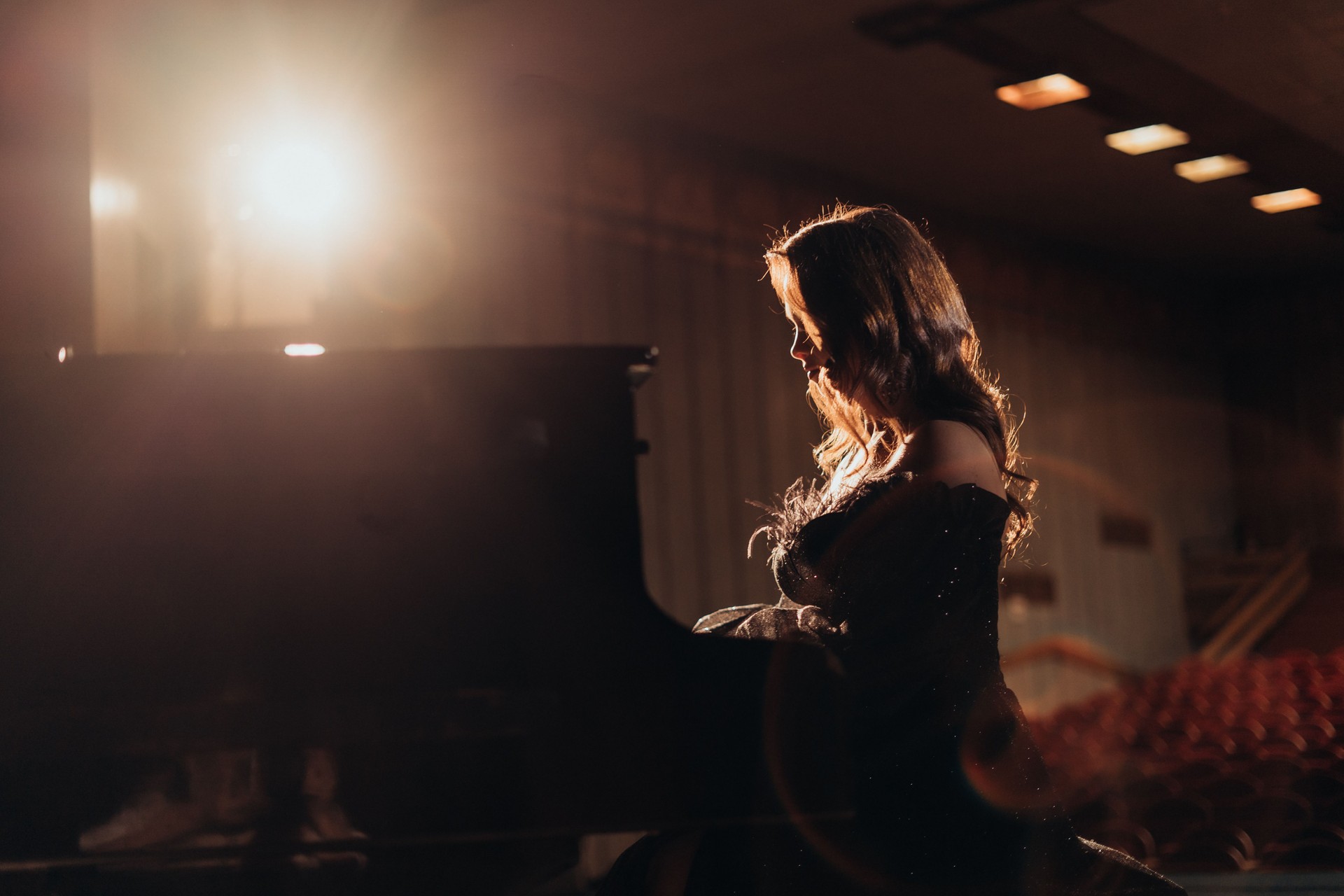 elegant Woman at the Piano Under Theater Lights