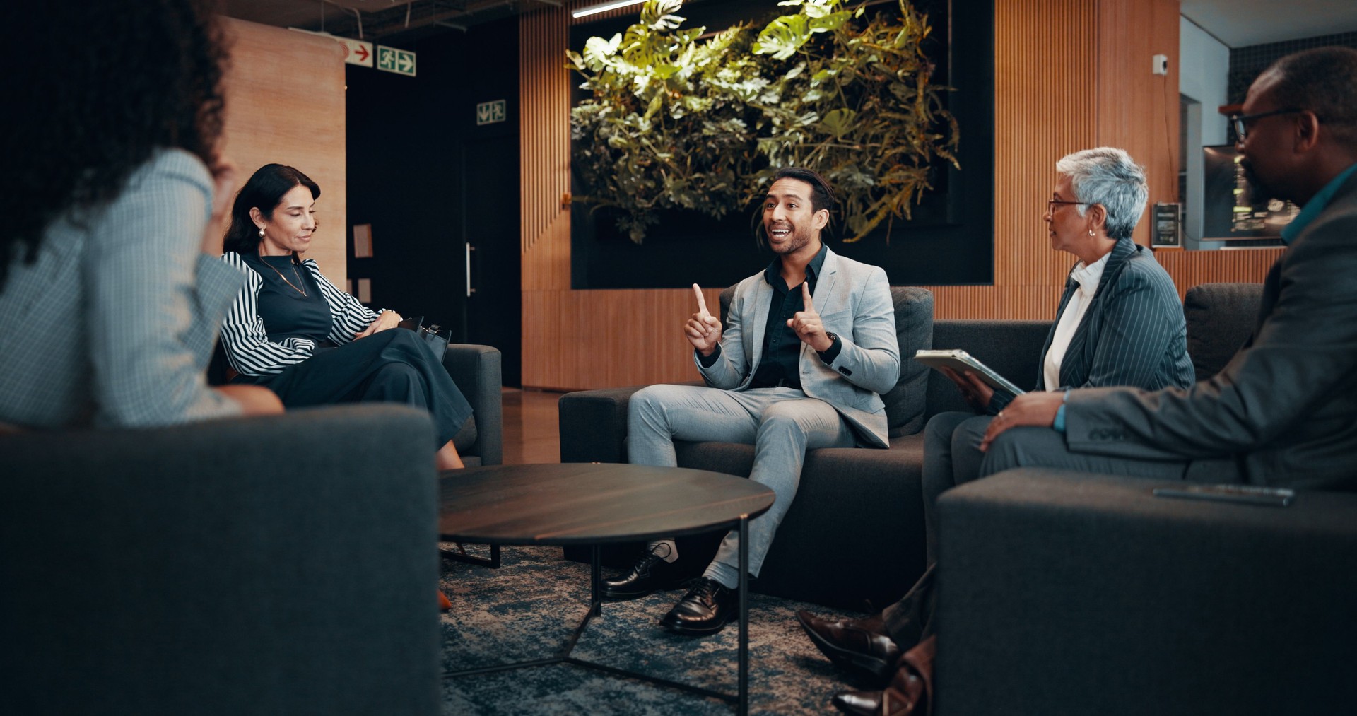 Group, business and meeting with people in lobby for discussion, planning and briefing at convention. Staff, talking and feedback of conference, corporate travel and chat for B2B negotiation at hotel